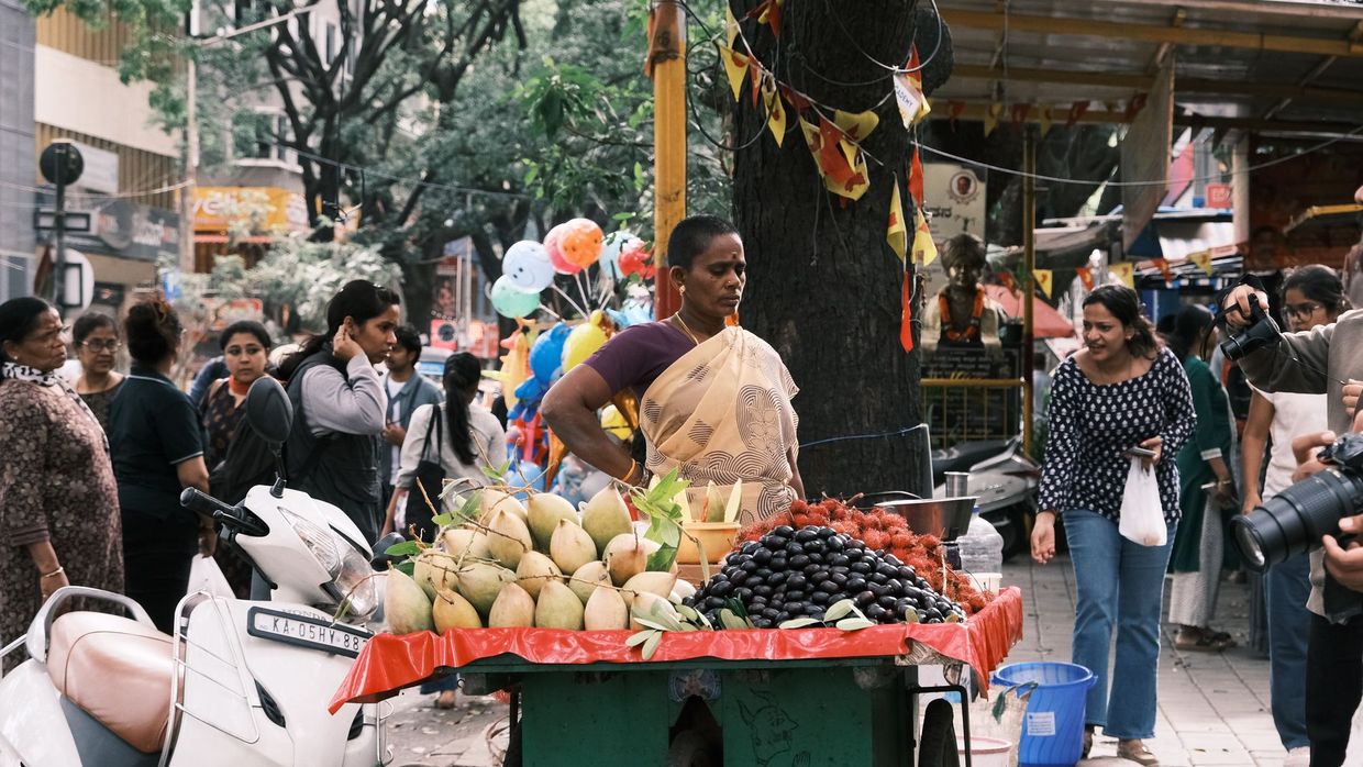 SEO salaries in India: a bustling street market scene in Bengaluru featuring a diverse crowd and fresh produce stall